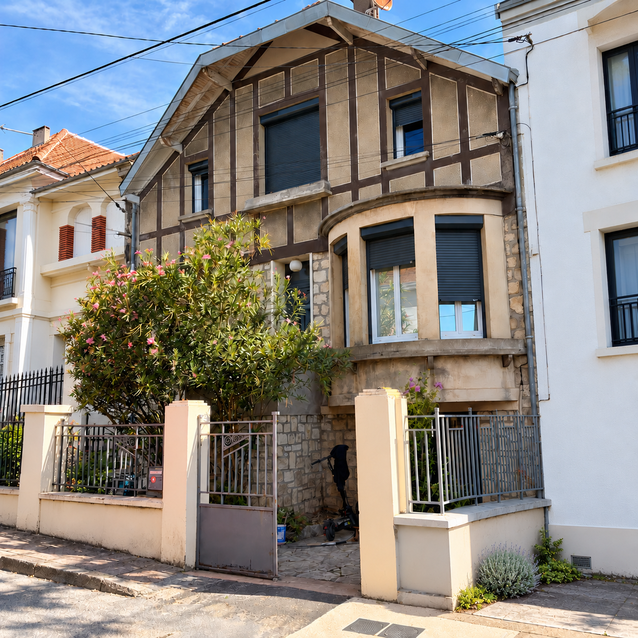 Façade de la maison avant le ravalement, avec murette et portail